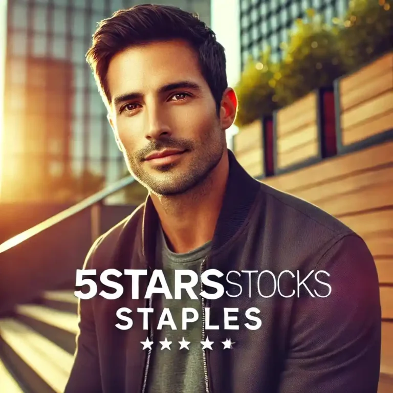 A man in a casual jacket smiling outdoors, with wooden steps and buildings behind